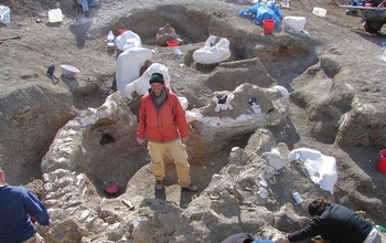 scientist with dinosaur skeleton